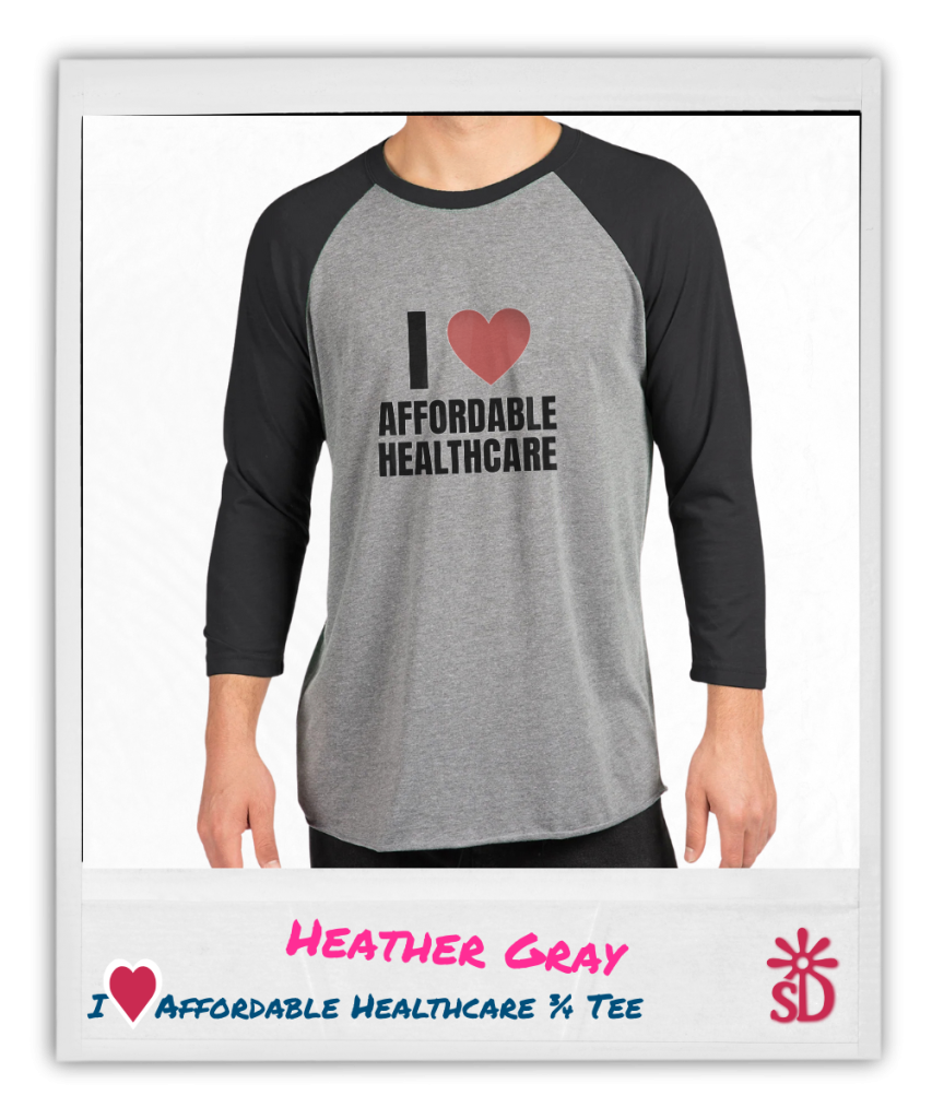 Person wearing a heather gray and black ¾ sleeve baseball tee with the words "I [heart] Affordable Healthcare" boldly printed on the front, standing against a light background.
